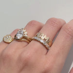 Video of the Mama Ring stacked with a diamond engagement ring and a gold signet on hand