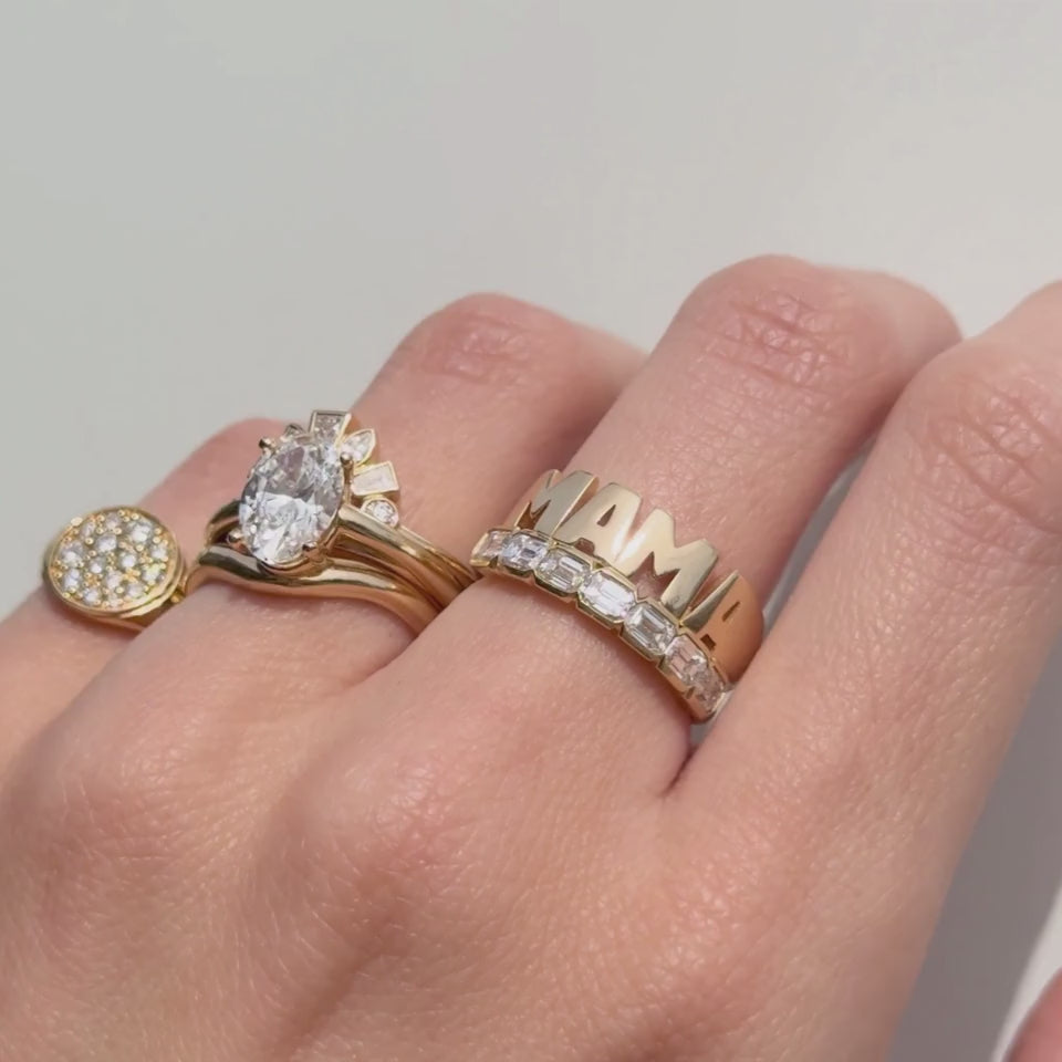 Video of the Mama Ring stacked with a diamond engagement ring and a gold signet on hand