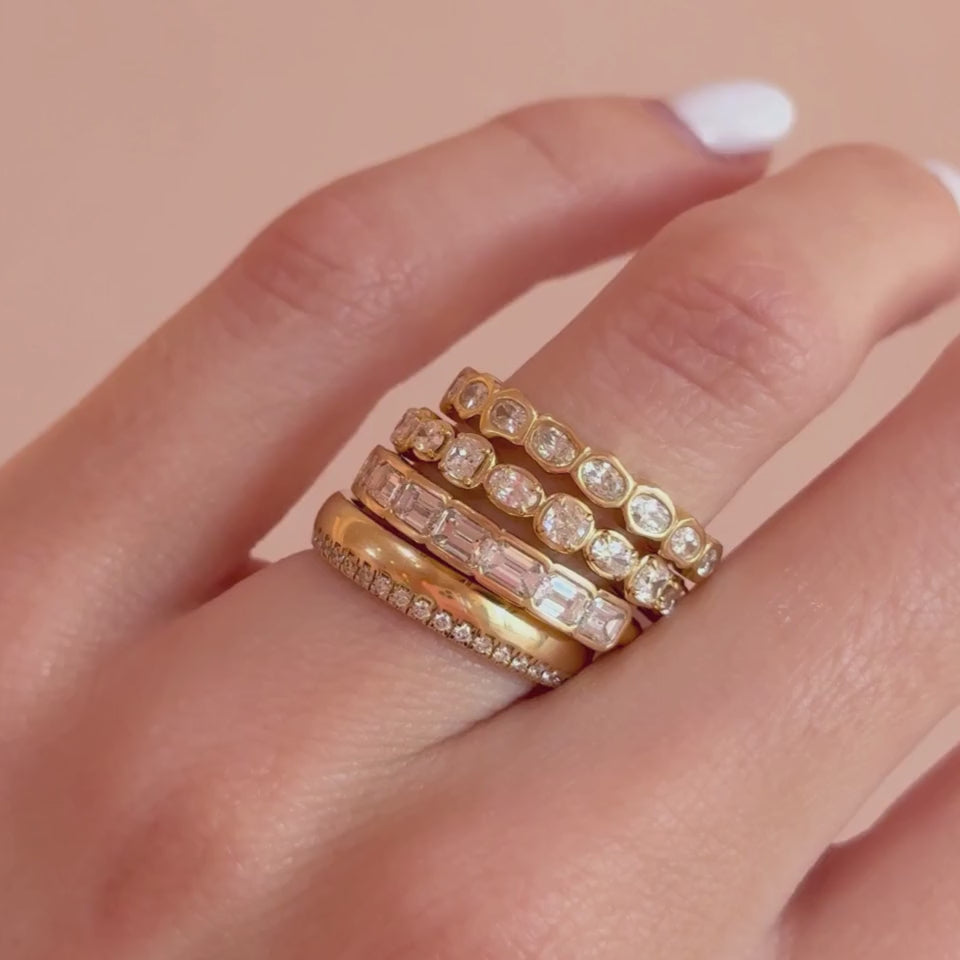 Video of five white diamond stacking bands worn together on hand