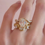 Video of the Arno Serpentine Band and Curved Pavé White Diamond Ring stacked with The Abstract Bezel Oval Engagement Ring on hand