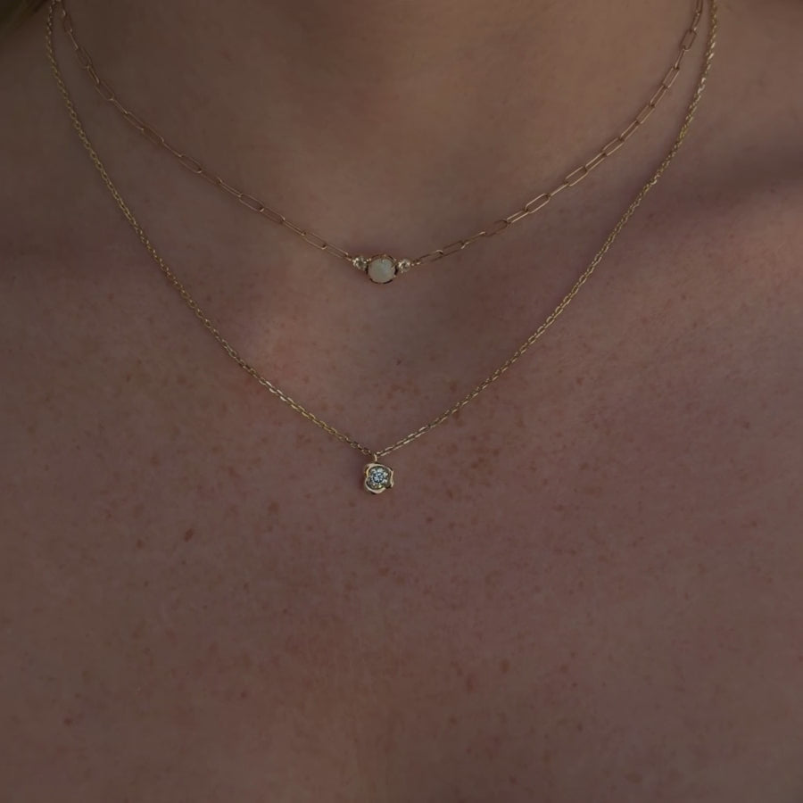 Video of White Diamond Abstract Bezel Necklace and Juliette Opal Necklace layered together on woman's neckline