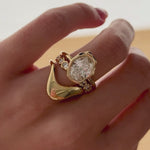 Video of the White Diamond Bombé Band stacked with a pear diamond engagement ring on hand