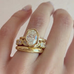 Video of The Abstract Bezel Oval Engagement Ring stacked with the Everyday Dome Ring and Lisse Eternity Band on hand