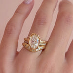Video of the White Diamond Bombé Band stacked with an oval diamond engagement ring on hand