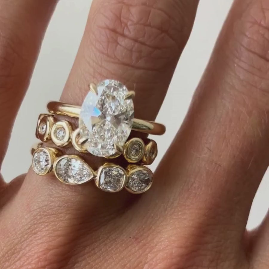 vide of The Francesca Oval Engagement Ring close up on finger, with white background
