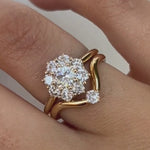 Video close up of hand featuring diamond rings against a neutral background