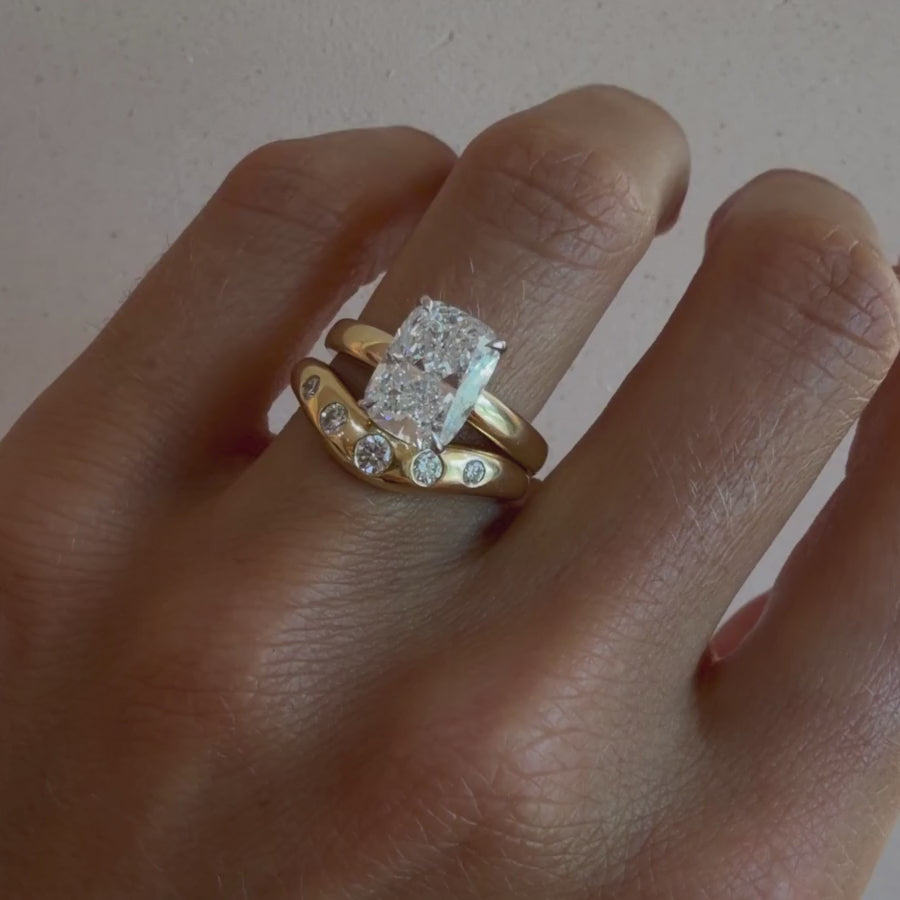 Video of the White Diamond Bombé Band paired with a diamond engagement ring on hand