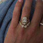 Video of the Simone Arch Band nested under a radiant cut diamond engagement ring on hand
