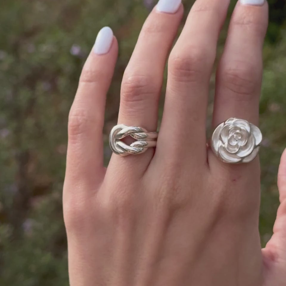Video of the sterling silver Alma Lover's Knot Ring and Rose Becoming Signet worn on hand