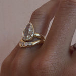 Video of the White Diamond Lola Bombe Band stacked with a pear diamond engagement ring on hand