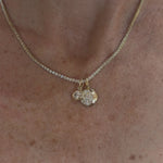 Video of Margaret Tennis Necklace with an east-west oval diamond charm and a gibbous moon charm
