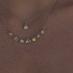Video of Lisse Diamond Cushion Charm and Lisse Seven Stone Necklace layered together on woman's neckline