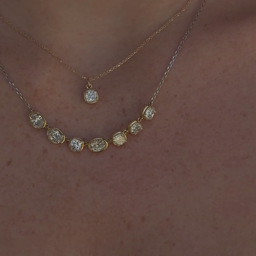Video of Lisse Diamond Cushion Charm and Lisse Seven Stone Necklace layered together on woman's neckline