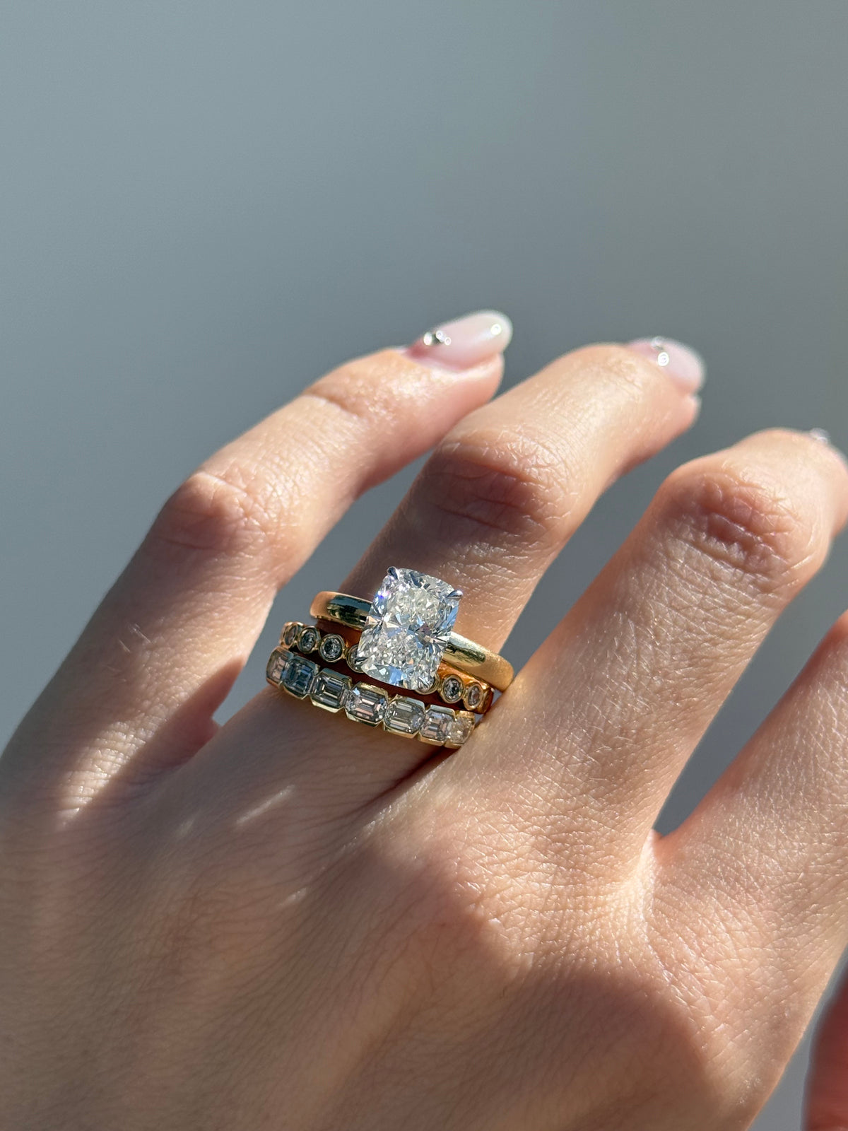 Peyton diamond engagement ring stacked with diamond bands on hand