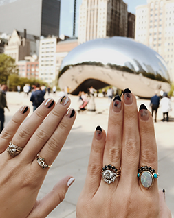 hands with Marrow Fine rings over Chicago's Cloud Gate sculpture