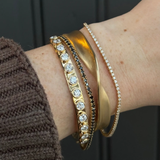 gold and diamond bracelets on woman's wrist ugc